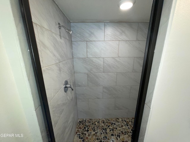 bathroom with tiled shower