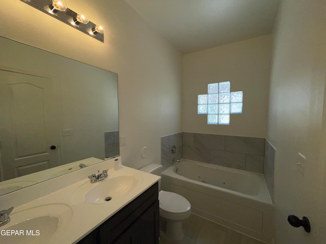 bathroom featuring toilet, oversized vanity, a bathtub, tile flooring, and dual sinks