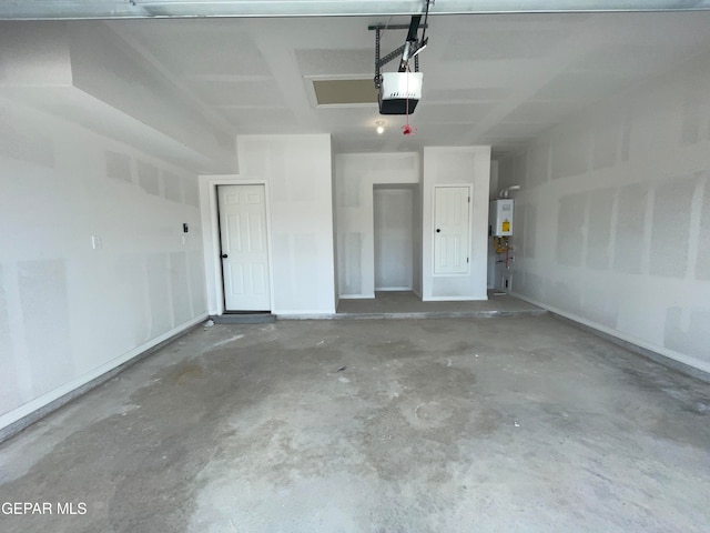 garage featuring a garage door opener and tankless water heater