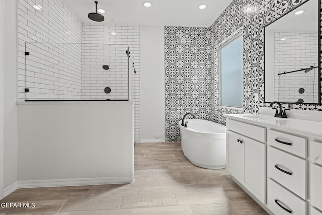 bathroom featuring tile floors, a washtub, and vanity with extensive cabinet space