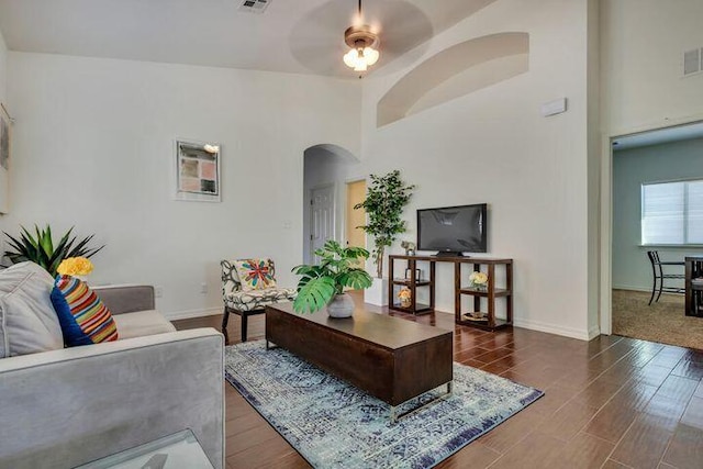 carpeted living room featuring ceiling fan and high vaulted ceiling