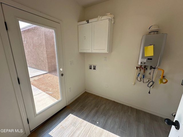 laundry room with plenty of natural light, tankless water heater, hardwood / wood-style flooring, and washer hookup