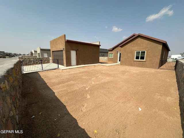 rear view of house with a garage