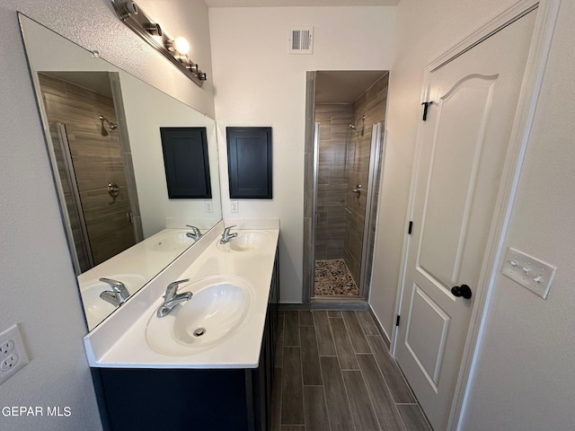 bathroom with walk in shower and double sink vanity