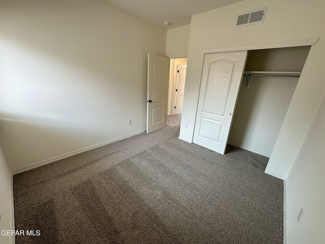 unfurnished bedroom featuring carpet and a closet