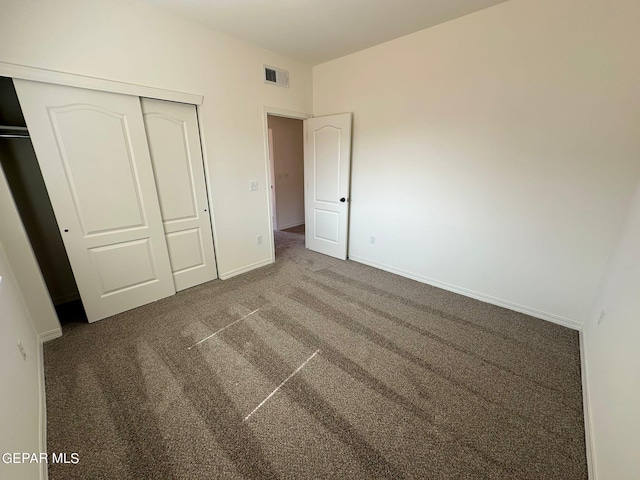 unfurnished bedroom with carpet and a closet