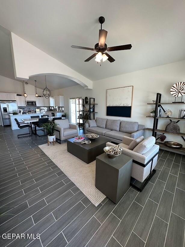 living room featuring dark hardwood / wood-style flooring and ceiling fan