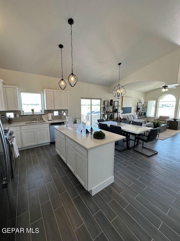 kitchen featuring white cabinets, decorative light fixtures, dark hardwood / wood-style floors, and a kitchen island