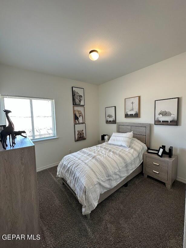 bedroom featuring dark carpet