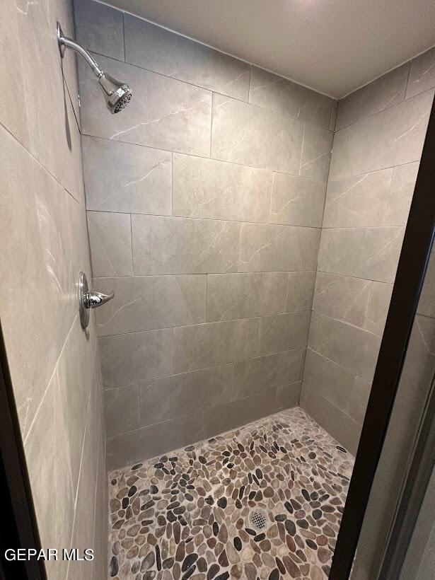 bathroom with a tile shower