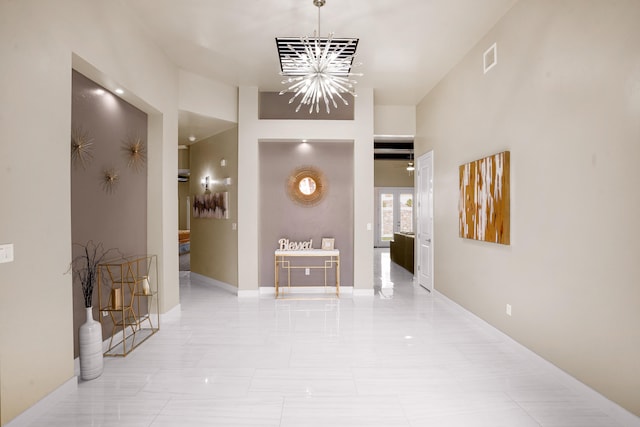 hall featuring an inviting chandelier and light tile floors