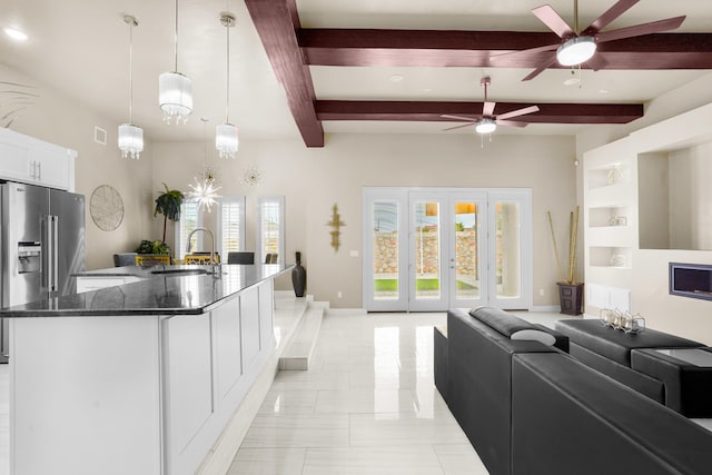 kitchen with french doors, ceiling fan, light tile floors, dark stone counters, and white cabinets