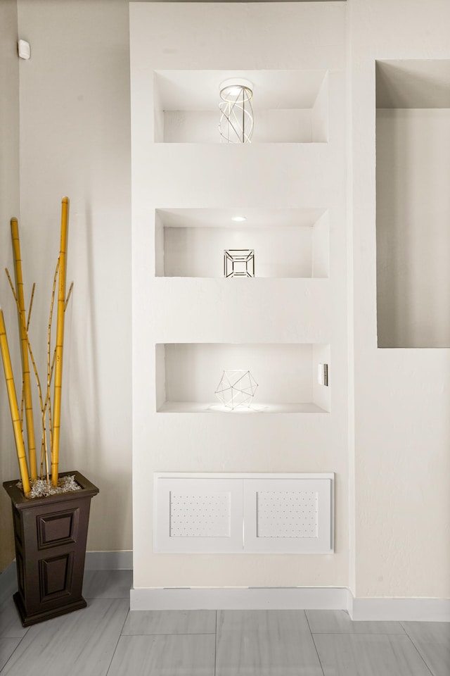 interior details with light tile flooring and built in features