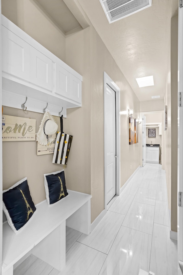 mudroom featuring light tile flooring