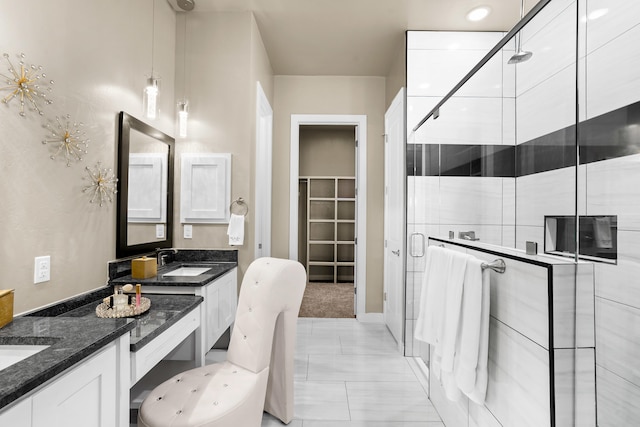 bathroom with a shower with door, double vanity, and tile floors