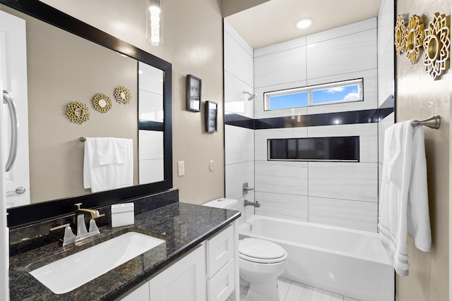 full bathroom with vanity, tile flooring, toilet, and tiled shower / bath