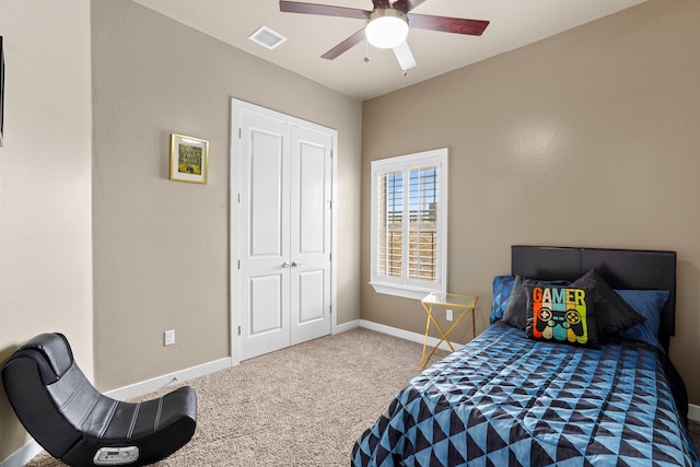 carpeted bedroom with a closet and ceiling fan