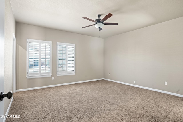 carpeted empty room featuring ceiling fan