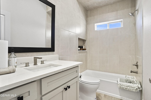 full bathroom with vanity, toilet, and tiled shower / bath combo