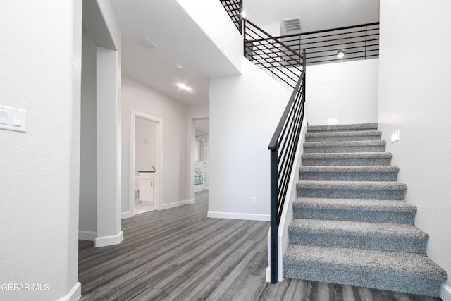 stairway with hardwood / wood-style flooring