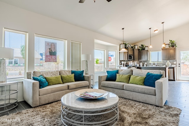 living room featuring dark hardwood / wood-style flooring, ceiling fan, and lofted ceiling