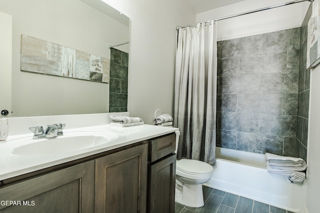 full bathroom with shower / bath combo with shower curtain, toilet, and vanity