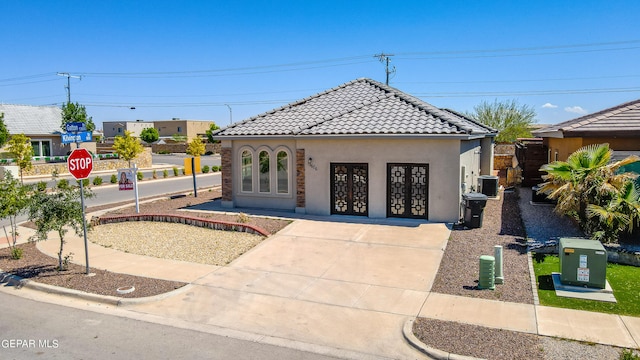 view of front of house with french doors and central air condition unit