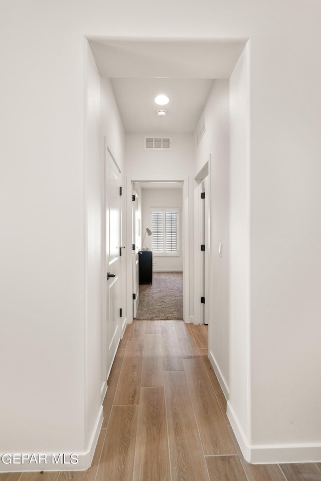 hall with light hardwood / wood-style flooring