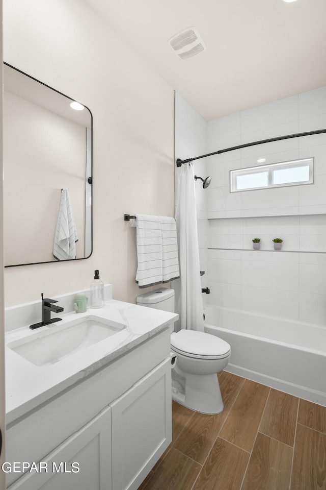 full bathroom featuring vanity, toilet, and shower / bathtub combination with curtain