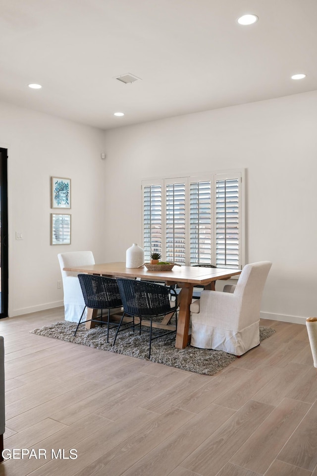 dining space with light hardwood / wood-style floors