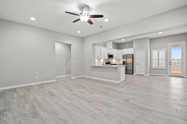 unfurnished living room with light hardwood / wood-style flooring and ceiling fan