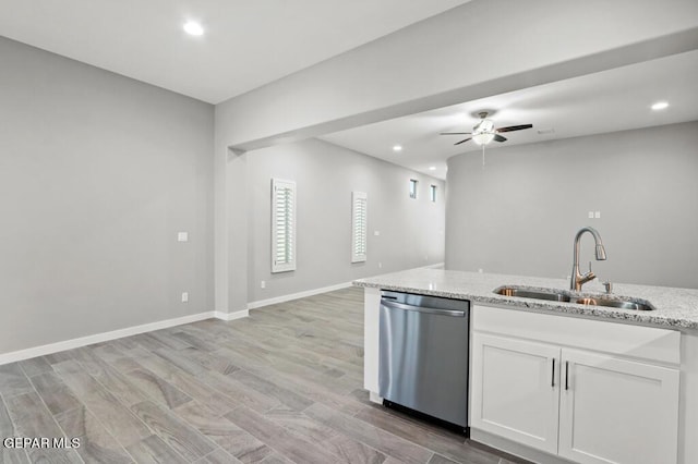 kitchen featuring sink, light hardwood / wood-style flooring, stainless steel dishwasher, light stone countertops, and white cabinetry