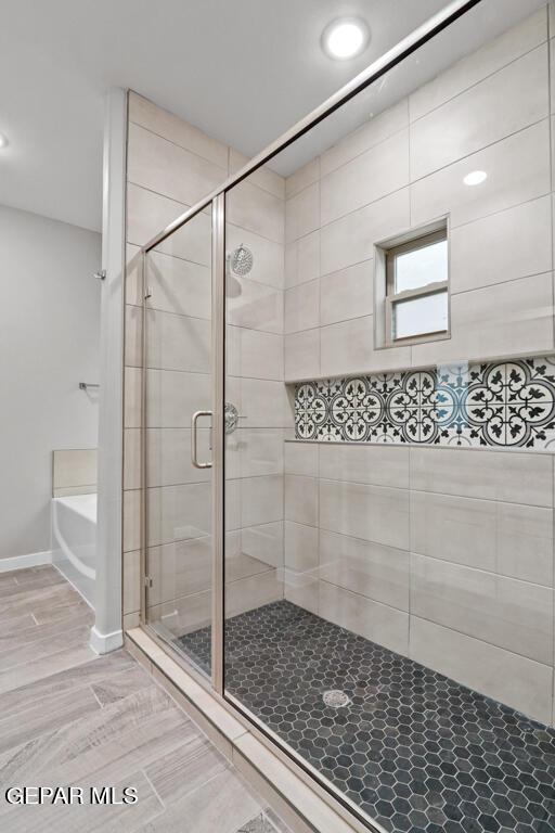 bathroom with shower with separate bathtub