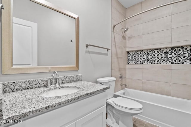 full bathroom featuring tile patterned flooring, vanity, toilet, and tiled shower / bath