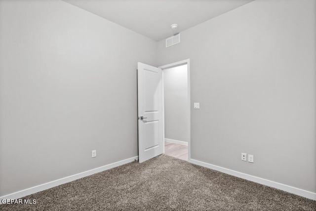 spare room with light colored carpet