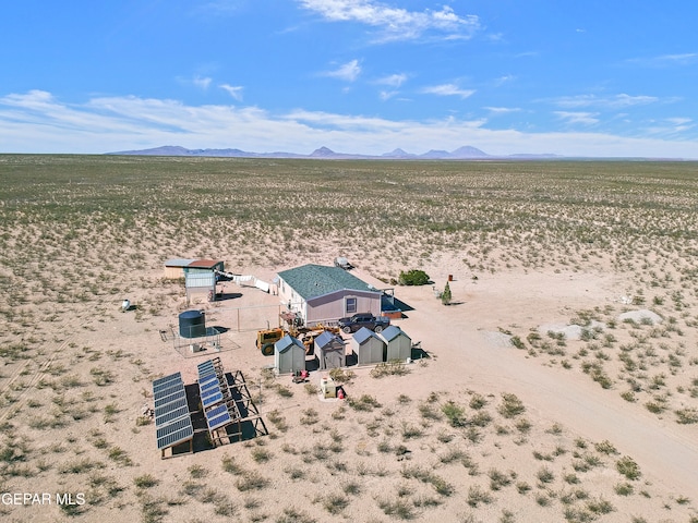 birds eye view of property featuring view of desert and a mountain view