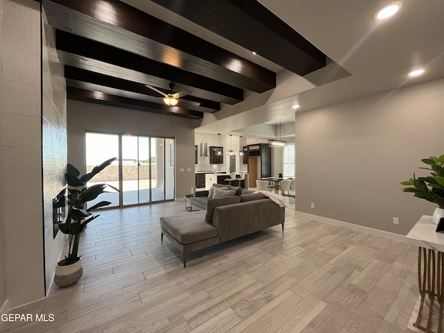 living room featuring beam ceiling, light hardwood / wood-style flooring, and ceiling fan