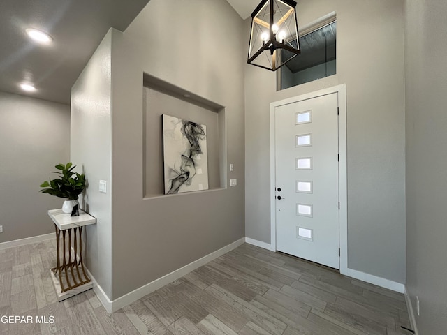 entrance foyer featuring hardwood / wood-style flooring and a chandelier