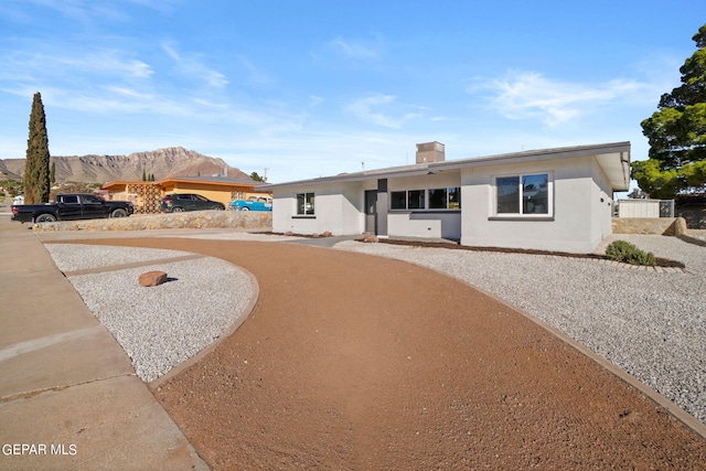 ranch-style home with a mountain view