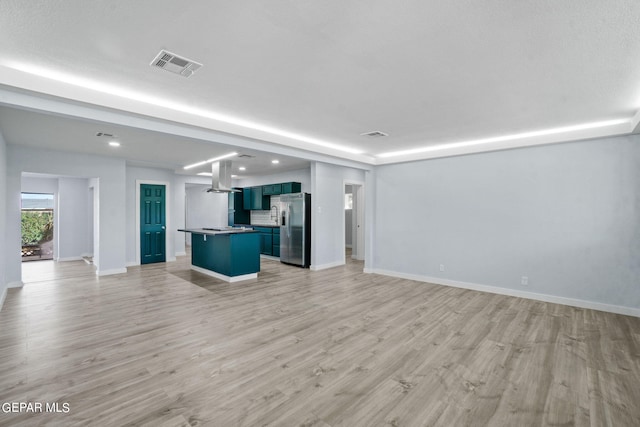 unfurnished living room with light hardwood / wood-style flooring