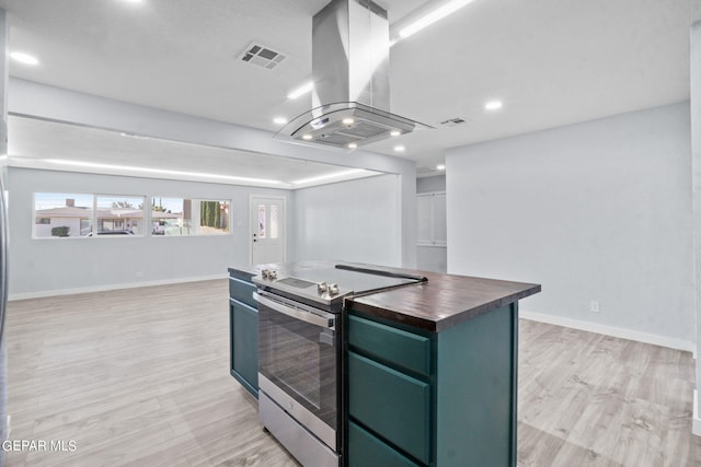 kitchen with light hardwood / wood-style floors, electric stove, a center island, green cabinets, and island exhaust hood