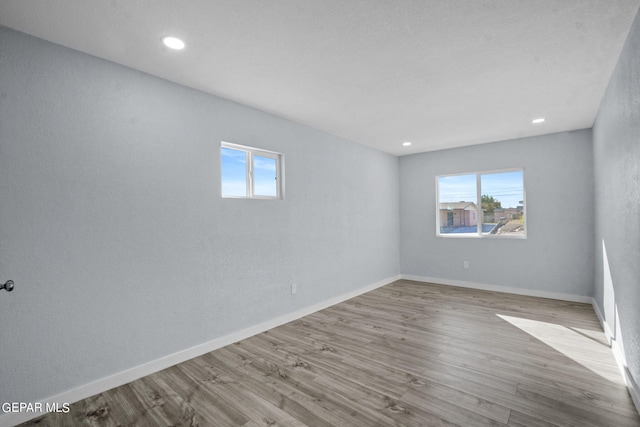 spare room featuring light hardwood / wood-style floors