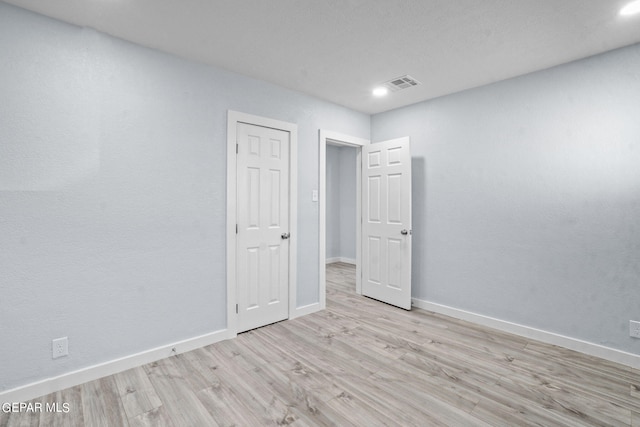 spare room with light hardwood / wood-style flooring