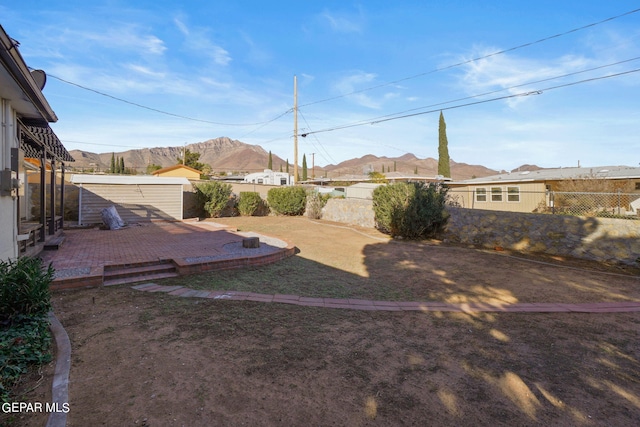 view of yard featuring a patio and a mountain view