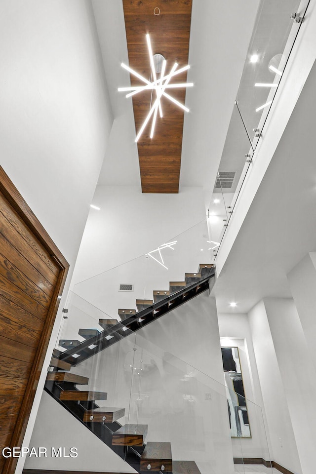 staircase featuring a towering ceiling