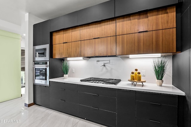 kitchen with appliances with stainless steel finishes and light tile floors