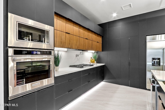 kitchen featuring appliances with stainless steel finishes and light tile floors