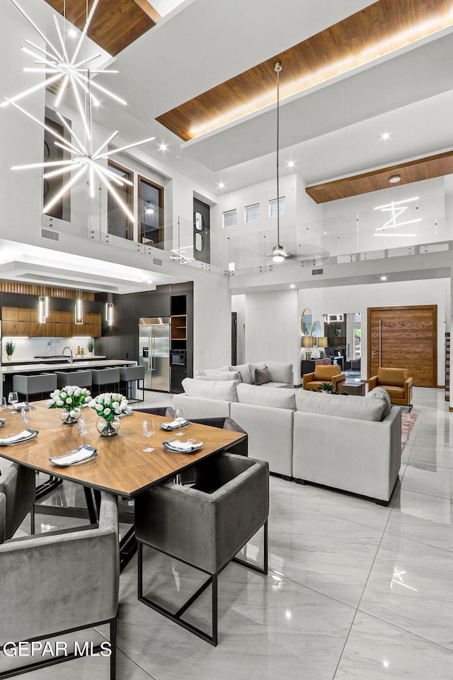 tiled dining space featuring an inviting chandelier, wooden ceiling, and a high ceiling