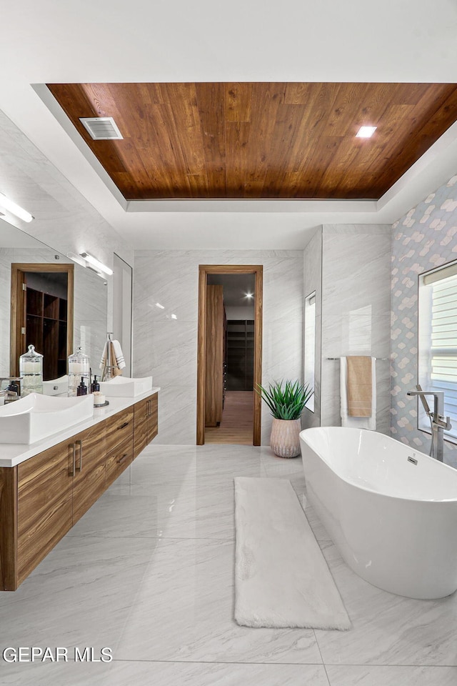 bathroom with tile flooring, wood ceiling, and a tray ceiling