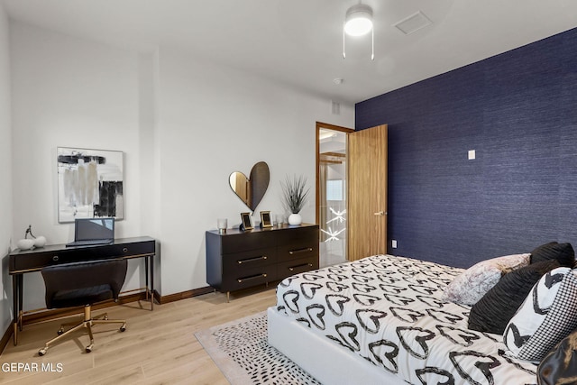 bedroom featuring ceiling fan and light wood-type flooring